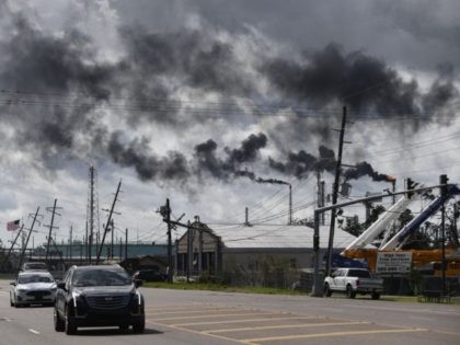 TOPSHOT - Vehicles drive past a petrol chemical plant near Highway 61 in Norco, Louisiana,