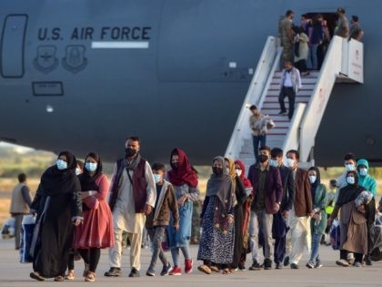 Refugees disembark from a US air force aircraft after an evacuation flight from Kabul at t
