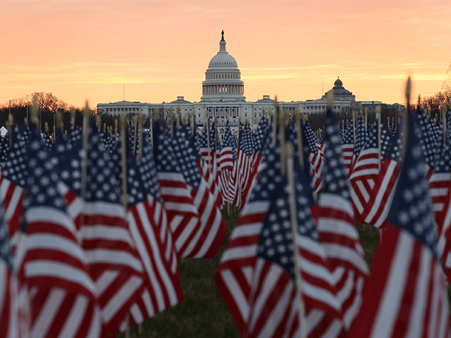 The U.S Capitol Building is prepared for the inaugural ceremonies for President-elect Joe Biden as American flags are placed in the ground on the National Mall on January 18, 2021 in Washington, DC. The approximately 191,500 U.S. flags will cover part of the National Mall and will represent the American …