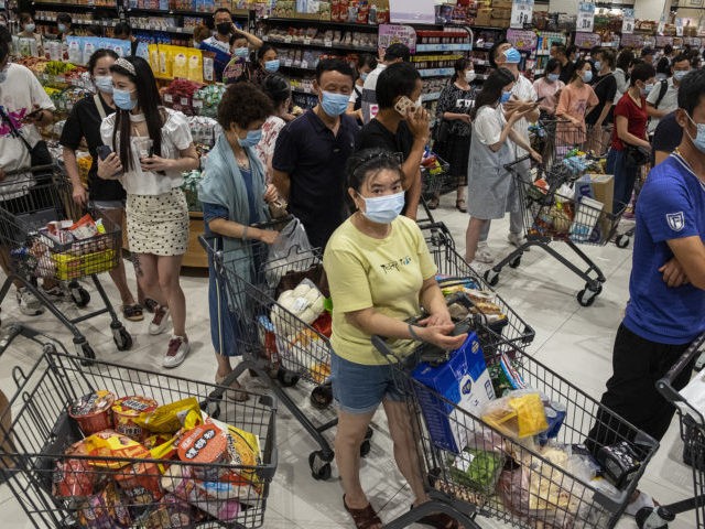 WUHAN, CHINA - AUGUST 2：(CHINA OUT) People wear protective masks as they line up to pay in a supermarket on August 2, 2021 in Wuhan, Hubei Province, China. According to media reports, seven migrant workers returned positive COVID-19 nucleic acid tests. Wuhan has not reported locally transmitted cases for over …