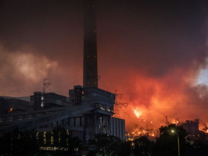 MUGLA, TURKEY - AUGUST 04: Fires burn at the back of the Kemerkoy Thermal Power Plant on August 04, 2021 in Mugla, Turkey. Large wildfires continue to burn across Turkey's southern coast for the seventh day. The death toll from the fires currently stands at eight according to Turkey's Health …