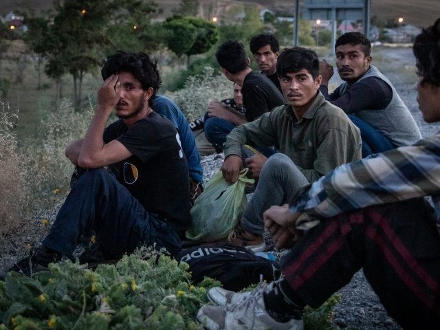 VAN, TURKEY - JULY 06: Afghan migrants look on as a Jandarma officer arrests the driver of a car smuggling fourteen Afghan migrants after a roadside raid on July 06, 2021 in Van, Turkey. A growing number of Afghan refugees are fleeing into Turkey as the Taliban escalates its military …