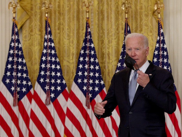 WASHINGTON, DC - AUGUST 16: U.S. President Joe Biden removes his face mask before delivering remarks on the worsening crisis in Afghanistan from the East Room of the White House August 16, 2021 in Washington, DC. Biden cut his vacation in Camp David short to address the nation as the …
