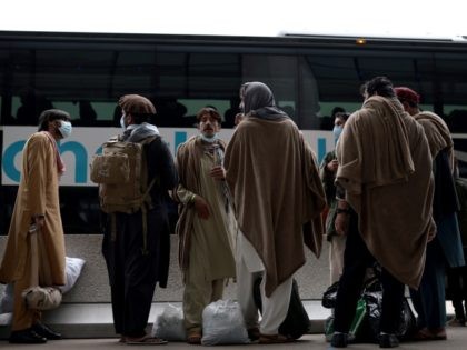 DULLES, VIRGINIA - AUGUST 31: Refugees board a bus at Dulles International Airport that wi