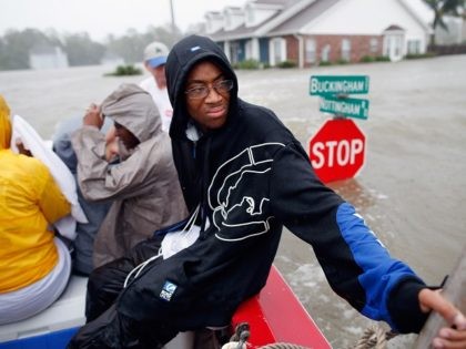 LAPLACE, LA - AUGUST 29: Christopher Smith rides in a boat after being rescued from the rising flood water from Hurricane Isaac in the River Forest subdivision on August 29, 2012 in LaPlace, Louisiana. The large Level 1 hurricane slowly moved across southeast Louisiana, dumping huge amounts of rain and …