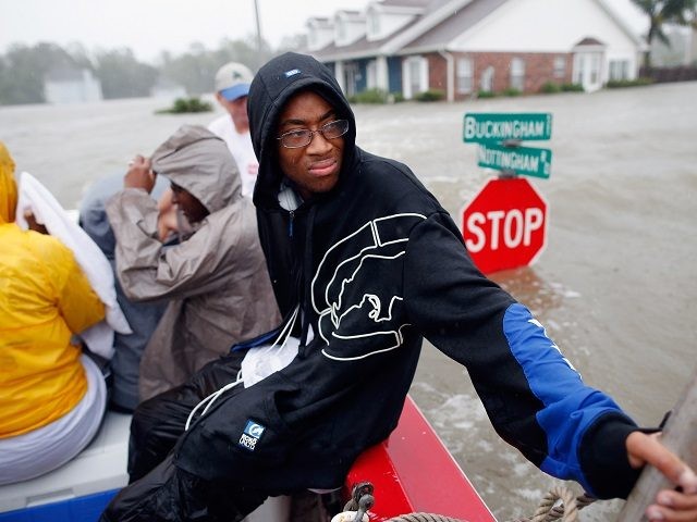 LAPLACE, LA - AUGUST 29: Christopher Smith rides in a boat after being rescued from the ri