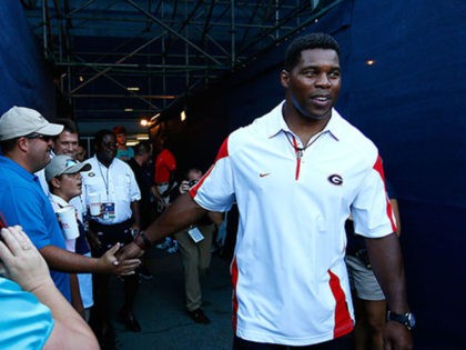 ATLANTA, GA - JULY 22: Herschel Walker walks onto Stadium court for the coin toss prior to the match between Nathan Pasha and Lukas Lacko of Slovakia during the BB&T Atlanta Open at Atlantic Station on July 22, 2014 in Atlanta, Georgia. (Photo by Kevin C. Cox/Getty Images)