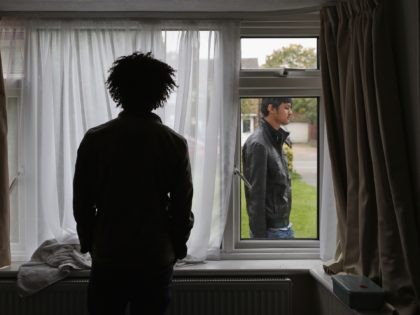 LONGFORD, ENGLAND - OCTOBER 14: Refugee man Merhawi, 25, from Eritrea stands inside his single room accommodation on October 14, 2015 in Longford, England. Merhawi says he has been staying in the room for 14 days with one other Syrian man awaiting papers and a transfer to more temporary accommodation. …