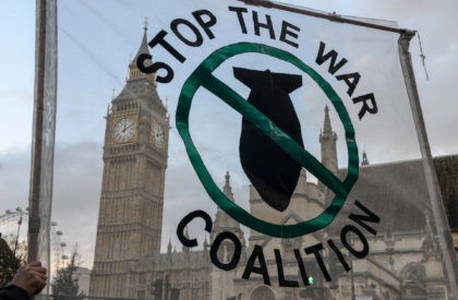 LONDON, ENGLAND - DECEMBER 02: Stop the War Coalition supporters hold up a banner outside