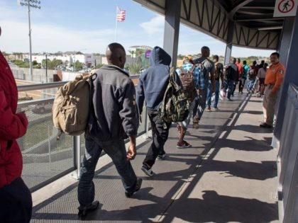Haitian migrants seeking asylum in the United States, queue at El Chaparral border crossin