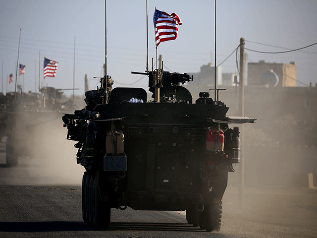A convoy of US forces armoured vehicles drives near the village of Yalanli, on the western outskirts of the northern Syrian city of Manbij, on March 5, 2017. / AFP PHOTO / DELIL SOULEIMAN (Photo credit should read DELIL SOULEIMAN/AFP via Getty Images)