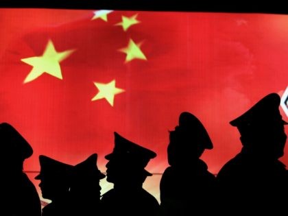 BEIJING, CHINA - MARCH 1: (CHINA OUT) Security guard walk past the Chinese national flag a