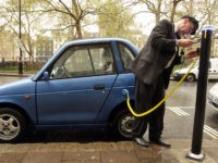 LONDON, ENGLAND - APRIL 16: Alexander Skeaping, an owner of a G-Wiz electric vehicle plugs into a in a charging bay in Berkeley Square on April 16, 2009 in London, England. The Government has today announced plans to offer subsidies of up to GBP5,000 to motorists who buy electric or …