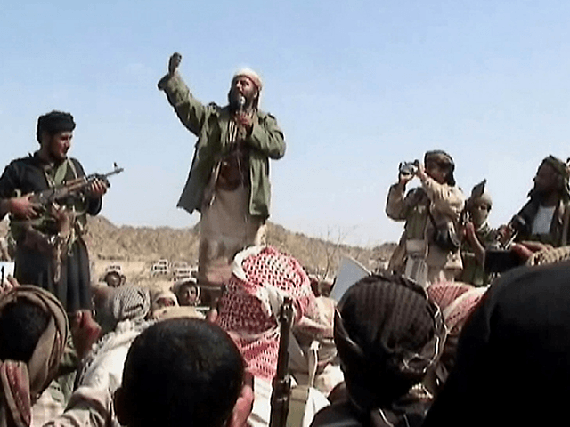 A man claiming to be an Al-Qaeda member addresses a crowd gathered in Yemen's southern pro
