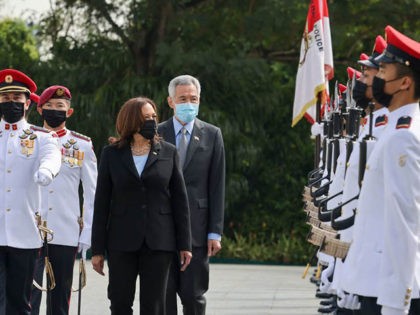 US Vice President Kamala Harris (C) inspects an honour guard with Singapore's Prime Minister Lee Hsien Loong (R) at the Istana in Singapore on August 23, 2021. (Photo by EVELYN HOCKSTEIN / POOL / AFP) (Photo by EVELYN HOCKSTEIN/POOL/AFP via Getty Images)