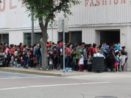 Migrants released by Border Patrol in McAllen, Texas, wait in line to enter an overcrowded Catholic Charities shelter (Photo: Randy Clark/Breitbart Texas)