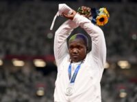 Team USA Shot Put Star Raises 'X' Overhead on Olympic Podium