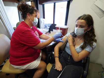 Hy Vee pharmacist Tiffany Aljets, left, gives a COVID-19 vaccination shot to eighteen-year-old exchange student Jonila Shehu, of Kosovo, Monday, Aug. 16, 2021, in Des Moines, Iowa. At the Iowa State Fair in Des Moines, where a million people are expected for the 11-day event, public health officials hope a …