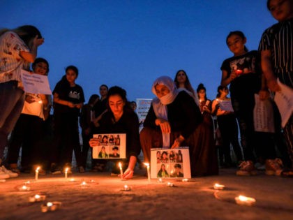 Iraqi Yazidis attend a candle-lit vigil in the Sharya area, some 15 kilometres from the northern city of Dohuk in the autonomous Iraqi Kurdistan region on August 3, 2020, marking the sixth anniversary of the Islamic State (IS) group's attack on the Yazidi community in the northwestern Sinjar district. (Photo …