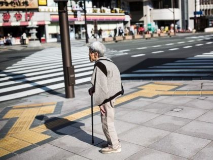 A Japanese elderly woman waits for the traffic light to cross the street in Nagano, northwest of the capital Tokyo on November 7, 2016. / AFP / BEHROUZ MEHRI (Photo credit should read BEHROUZ MEHRI/AFP via Getty Images)