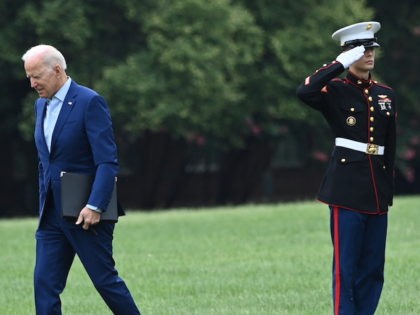 US President Joe Biden past a member of the military after arriving at Fort McNair in Wash