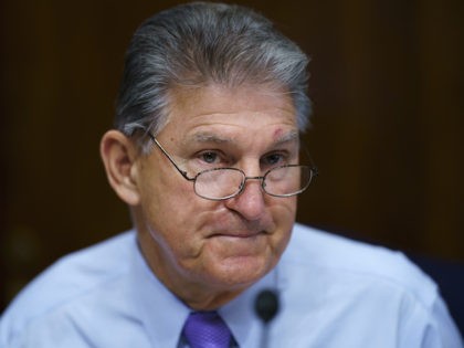 Sen. Joe Manchin, D-W.Va., prepares to chair a hearing in the Senate Energy and Natural Resources Committee, as lawmakers work to advance the $1 trillion bipartisan bill, at the Capitol in Washington, Thursday, Aug. 5, 2021. (AP Photo/J. Scott Applewhite)
