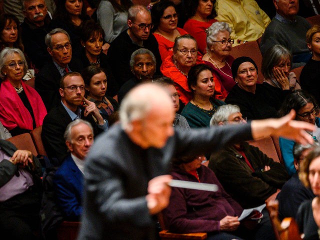 Audience members watch as Italian conductor Gianandrea Noseda conducts the National Sympho