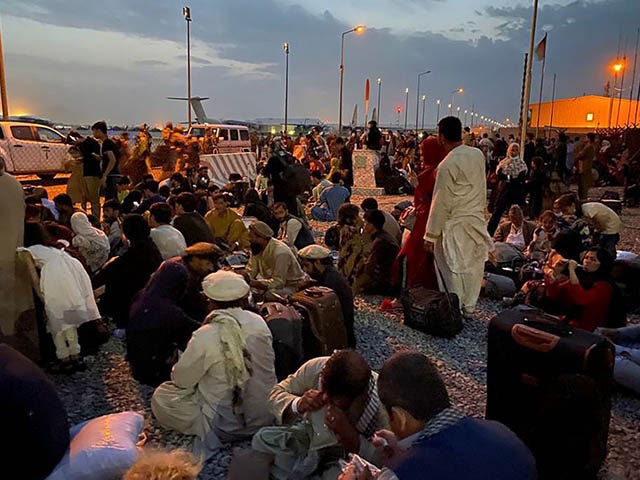 Afghan people wait to board a U S military aircraft to leave Afghanistan, at the military airport in Kabul on August 19, 2021 after Taliban's military takeover of Afghanistan. (Photo by Shakib RAHMANI / AFP) (Photo by SHAKIB RAHMANI/AFP via Getty Images)