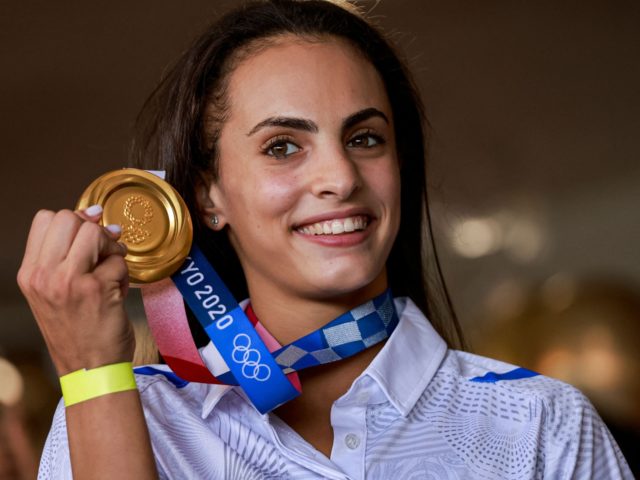 Israel's Rhythmic Gymnastics gold medalist Linoy Ashram poses with her medal upon arrival