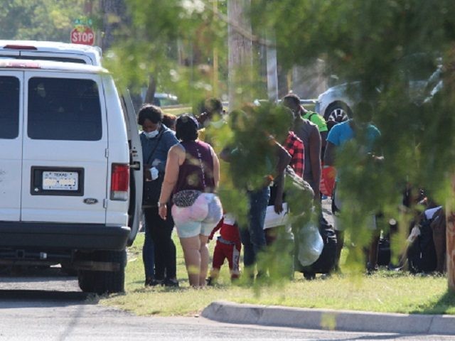 A non-profit migant shelter group loads a group of migrants in a van in defiance of Governor Abbott's executive order banning ground transportation of migrants released by CBP. (Photo: Randy Clark/Breitbart Texas)