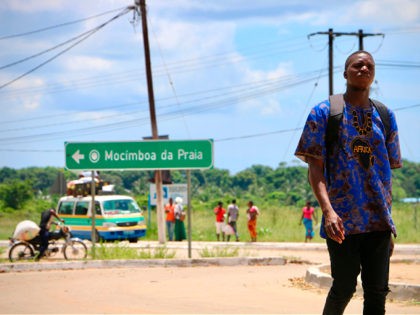 A man walks by the main entrance to the city on March 8, 2018 in Mocimboa da Praia, Mozambique. Security is increased in the area following a two days attack from suspected islamists in October last year where they took control of the city. / AFP PHOTO / ADRIEN BARBIER …