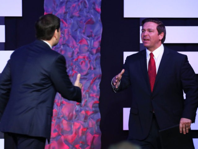 DORAL, FLORIDA - FEBRUARY 01: Florida Gov. Ron DeSantis prepares to shake hands with Sen. Marco Rubio (R-FL) as he prepares to speak before Vice President Mike Pence takes to the stage at Iglesia Doral Jesus Worship Center after meeting with Venezuelan exiles and community leaders on February 01, 2019 …