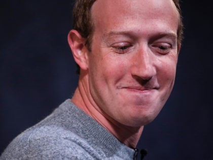 Mark Zuckerberg swallows a giggle. Drew Angerer /Getty
