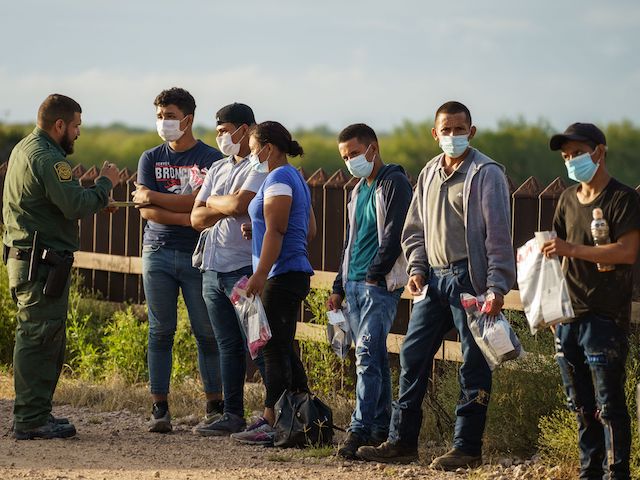 Migrants are processed by United States Border Patrol after crossing the US-Mexico border into the United States in Penitas, Texas on July 8, 2021. - Republican lawmakers have slammed Biden for reversing Trump programs, including his "remain in Mexico" policy, which had forced thousands of asylum seekers from Central America to stay south of the US border until their claims were processed. (Photo by PAUL RATJE / AFP) (Photo by PAUL RATJE/AFP via Getty Images)