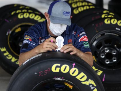 DARLINGTON, SOUTH CAROLINA - MAY 19: A crew member in a mask checks the tires in the garage area prior to the NASCAR Xfinity Series Toyota 200 at Darlington Raceway on May 19, 2020 in Darlington, South Carolina. (Photo by Chris Graythen/Getty Images)