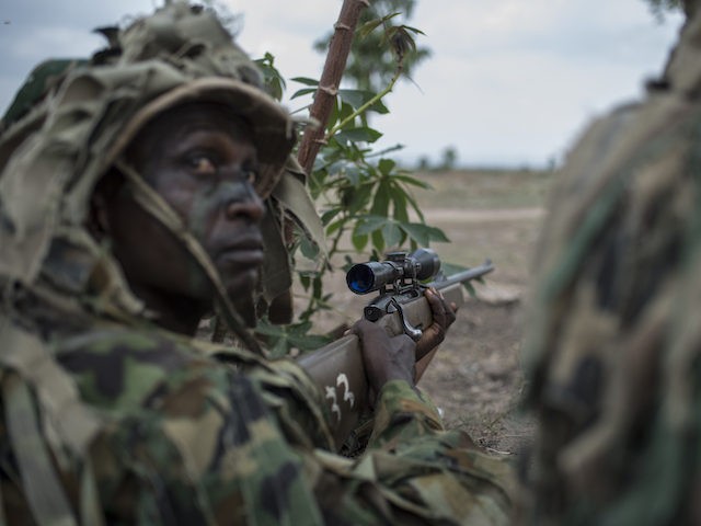 TOPSHOT - A member of the Nigerian Armed Forces Sniper Unit wearing a ghillie suit takes p