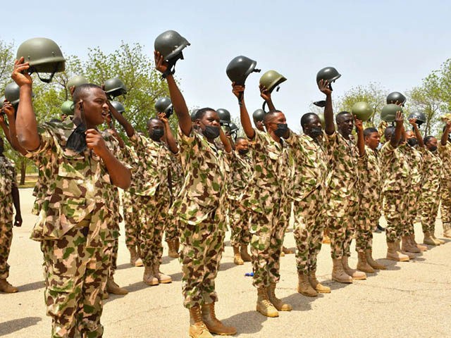 Soldiers gesture while standing on guard during Nigerian President Muhammadu Buhari's visi