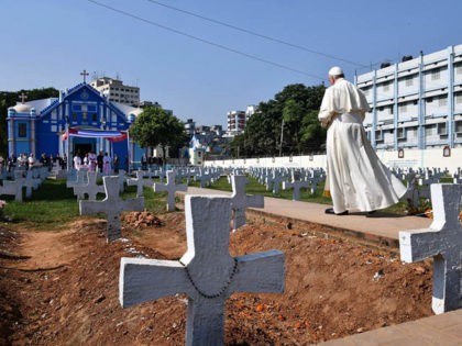 Pope Francis performs a blessing ritual at a graveyard in the Church of the Holy Rosary co