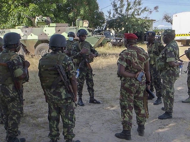 In this image made from video, Rwandan and Mozambican soldiers gather at the airport in Mocimboa da Praia, Cabo Delgado province, Mozambique Monday, Aug. 9, 2021. Fresh from recapturing the strategic northern Mozambican port of Mocimboa da Praia held by Islamic extremist rebels for a year, Rwandan and Mozambican troops …