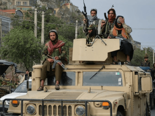 Taliban fighters atop a Humvee vewhicle take part in a rally in Kabul on August 31, 2021 a
