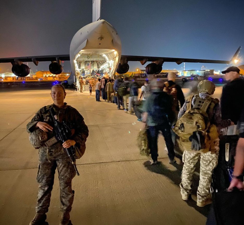 Picture of U.S. Marine Sgt. Nicole Gee helping evacuate people from Kabul, Afghanistan. She posted to Instagram with the caption, "Escorting evacuees onto the Bird," followed by a heart emoji. Screenshot via Instagram.