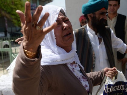 An Afghan Sikh woman weeps during a burial ceremony following a suicide attack in Jalalaba