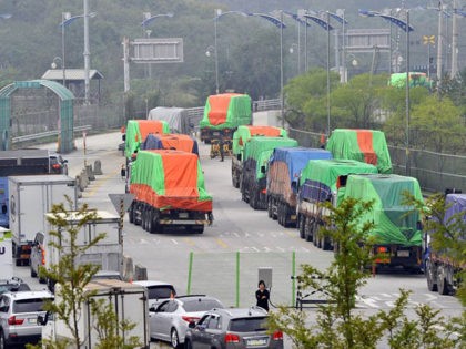 South Korean trucks carrying 500 tons of flour for North Korean flood victims move into North Korea across the heavily fortified border in Paju, north of Seoul, on September 21, 2021. A Seoul charity group sent flood aid to North Korea since the communist state was hit by a string …