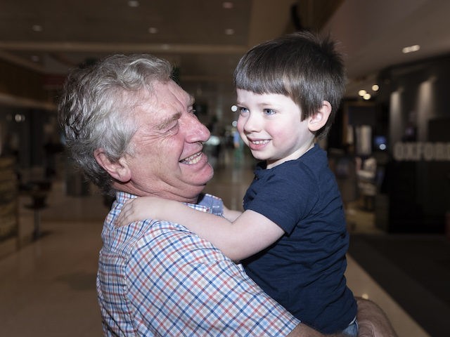 SYDNEY, AUSTRALIA - NOVEMBER 23: Sydney based Grandad Alan Kinkade reunites with his grandson Tom after six months of separation at Sydney domestic airport at on November 23, 2020 in Sydney, Australia. The New South Wales reopened its border to Victoria at 12:01 on Monday 23 November, with people able …