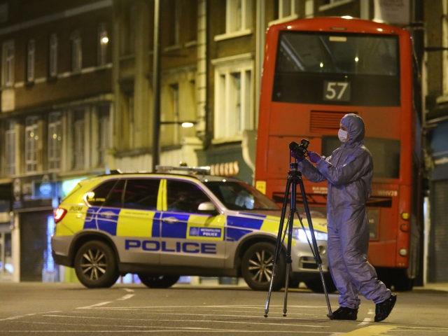 A police forensic officer works on Streatham High Road in south London on February 2, 2020, after a man is shot dead by police following reports of people being stabbed in the street. - British police on Sunday said they had shot a man in south London, after at least …