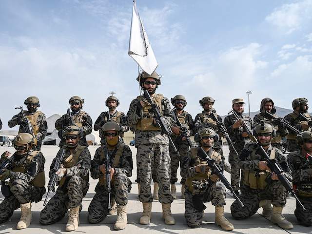Members of the Taliban Badri 313 military unit take a position at the airport in Kabul on