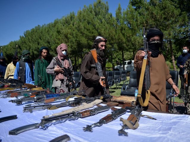 Taliban fighters put down their weapons as they surrendered to join the Afghanistan govern