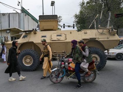 TOPSHOT - Taliban fighters patrol along a street in Kabul on August 17, 2021, as the Taliban moved to quickly restart the Afghan capital following their stunning takeover of Kabul and told government staff to return to work. (Photo by Wakil KOHSAR / AFP) (Photo by WAKIL KOHSAR/AFP via Getty …