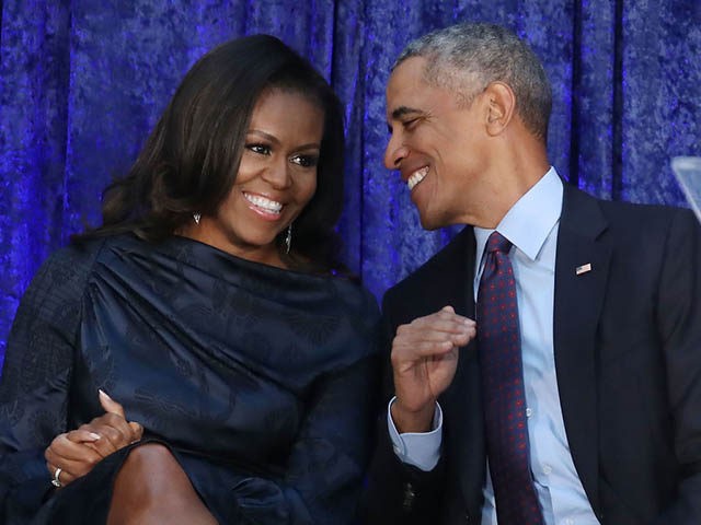 WASHINGTON, DC - FEBRUARY 12: Former U.S. President Barack Obama and first lady Michelle Obama participate in the unveiling of their official portraits during a ceremony at the Smithsonian's National Portrait Gallery, on February 12, 2018 in Washington, DC. The portraits were commissioned by the Gallery, for Kehinde Wiley to …