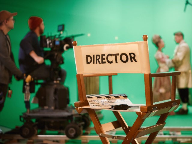 On Film Studio Set Focus on Empty Director's Chair. In the Background Professional Cr